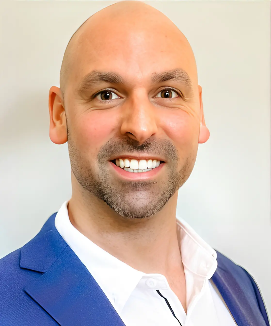Smiling man in blue suit jacket.