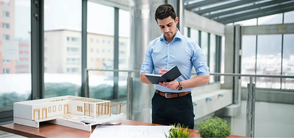 Architect reviewing plans in modern office.